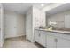Double vanity bathroom with white cabinets and a large mirror at 2874 Stanza Ct, Kissimmee, FL 34746