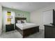 Bedroom with a dark wood bed frame and green accent wall at 2874 Stanza Ct, Kissimmee, FL 34746