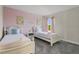 Bedroom with two twin beds, nightstand, and window at 2874 Stanza Ct, Kissimmee, FL 34746