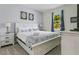 King-size bed, nightstands, and coastal decor at 2874 Stanza Ct, Kissimmee, FL 34746