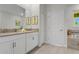 Double vanity bathroom with large mirror and white cabinets at 2874 Stanza Ct, Kissimmee, FL 34746