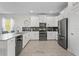 Modern kitchen with white cabinets, stainless steel appliances, and a large island at 2874 Stanza Ct, Kissimmee, FL 34746