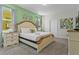 Main bedroom with large bed, nightstands, and green accent wall at 2874 Stanza Ct, Kissimmee, FL 34746