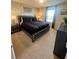 King-size bed, nightstands, and window with neutral decor at 2442 Tangier Dr, Kissimmee, FL 34747