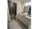 Bathroom with double vanity, shower, and bathtub at 2442 Tangier Dr, Kissimmee, FL 34747