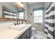 Clean bathroom with a vanity, walk-in shower, and striped curtains at 2090 Lakebreeze Way, Deltona, FL 32738