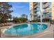 Inviting community pool with building reflection at 155 S Court Ave # 1804, Orlando, FL 32801