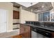 Modern kitchen with dark wood cabinets and granite countertops at 155 S Court Ave # 1804, Orlando, FL 32801