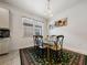 Breakfast nook with glass table and green patterned rug at 3052 Cardillino Way, Kissimmee, FL 34741