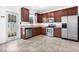 Modern kitchen featuring stainless steel appliances and dark wood cabinets at 2886 Grasmere View Pkwy, Kissimmee, FL 34746