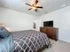 Bedroom with queen bed, dresser, and TV at 8914 Zurich Ln, Kissimmee, FL 34747