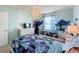 Well-lit bedroom featuring twin beds, Frozen-themed decor, and a dresser at 8914 Zurich Ln, Kissimmee, FL 34747