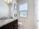 Convenient bathroom with granite vanity and toilet at 8914 Zurich Ln, Kissimmee, FL 34747