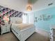 Bedroom with white bed frame and tropical wallpaper at 8914 Zurich Ln, Kissimmee, FL 34747