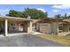 Exterior view of home showcasing carport and a courtyard at 1910 Abbington St, Apopka, FL 32712