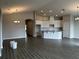 Modern kitchen with granite countertops, white cabinets, and tile floors at 2577 Great Heron Ave, Saint Cloud, FL 34773