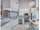 Modern kitchen with white cabinets, granite counters, and mosaic backsplash at 322 E Central Blvd # 401, Orlando, FL 32801