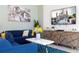 Living room with blue sofa and large TV at 4326 Scene Ln, Kissimmee, FL 34746