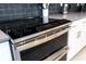 Sleek kitchen with stainless steel range and dark tile backsplash at 4326 Scene Ln, Kissimmee, FL 34746