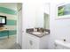 Modern bathroom with gray vanity, white cabinet, and corner sink at 4326 Scene Ln, Kissimmee, FL 34746