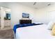 King-size bed with blue blanket, dresser and en-suite bathroom at 4326 Scene Ln, Kissimmee, FL 34746