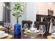 Elegant dining room featuring a dark wood table, blue vase, and place settings at 4326 Scene Ln, Kissimmee, FL 34746