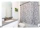 Clean bathroom with gray vanity, white cabinet, and patterned shower curtain at 4326 Scene Ln, Kissimmee, FL 34746