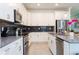 Modern kitchen with stainless steel appliances and white cabinets at 4326 Scene Ln, Kissimmee, FL 34746