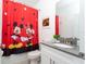 Charming bathroom with Mickey Mouse shower curtain and gray vanity at 4326 Scene Ln, Kissimmee, FL 34746