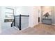 Upstairs hallway with black railing and carpet at 4326 Scene Ln, Kissimmee, FL 34746