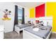 Mickey Mouse themed bedroom with twin beds and bright walls at 4326 Scene Ln, Kissimmee, FL 34746