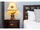 Nightstand with lamp, dresser, and bed in a well-lit bedroom at 4326 Scene Ln, Kissimmee, FL 34746