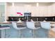 Modern kitchen with white cabinets, breakfast bar and stainless steel appliances at 4326 Scene Ln, Kissimmee, FL 34746