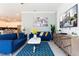 Living room with blue sofa and open kitchen view at 4326 Scene Ln, Kissimmee, FL 34746