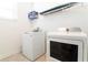 Laundry room with washer, dryer, and shelving at 4326 Scene Ln, Kissimmee, FL 34746