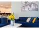 Living room with blue sofa and yellow flowers at 4326 Scene Ln, Kissimmee, FL 34746