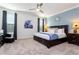 Spacious main bedroom with king-size bed, dark wood furniture and ceiling fan at 4326 Scene Ln, Kissimmee, FL 34746