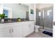 Double vanity with grey countertop, and a walk-in shower at 4326 Scene Ln, Kissimmee, FL 34746
