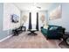 Teal couch, coffee table, and 3D wall in a living room at 4326 Scene Ln, Kissimmee, FL 34746