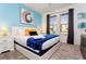Spacious bedroom with a king-size bed, blue accent pillows and large windows at 4326 Scene Ln, Kissimmee, FL 34746