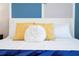 King-size bed with blue blanket and yellow pillows at 4326 Scene Ln, Kissimmee, FL 34746