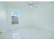 Bright bedroom with tile floors, window, and ceiling fan at 1048 Plantation Dr # E-9, Kissimmee, FL 34741