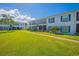 Exterior view of the condo building and lush lawn at 1048 Plantation Dr # E-9, Kissimmee, FL 34741