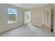 Bright bedroom with carpet, large window, and access to hallway at 3744 Sagefield Dr, St Cloud, FL 34773