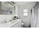 Updated bathroom with white tile and a new vanity at 1009 Loves Point Dr, Leesburg, FL 34748