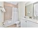 Bathroom with white vanity, tub, and shower at 8103 Coconut Place, Kissimmee, FL 34747
