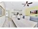 Bright dining area with a large table and access to the kitchen at 8103 Coconut Place, Kissimmee, FL 34747