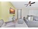 Living room with gray sofa, ottoman, and a large TV at 8103 Coconut Place, Kissimmee, FL 34747
