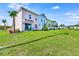 Row of colorful townhomes with grassy yard at 8103 Coconut Place, Kissimmee, FL 34747