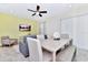 Bright dining area with table, bench, and chairs, adjacent to living room at 8103 Coconut Place, Kissimmee, FL 34747